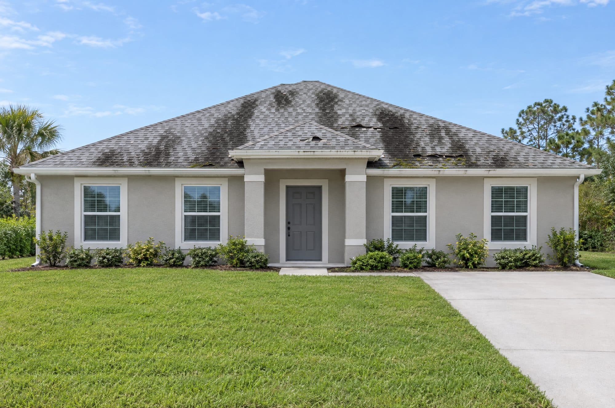 The same sample home with an old, worn shingle roof (illustration)